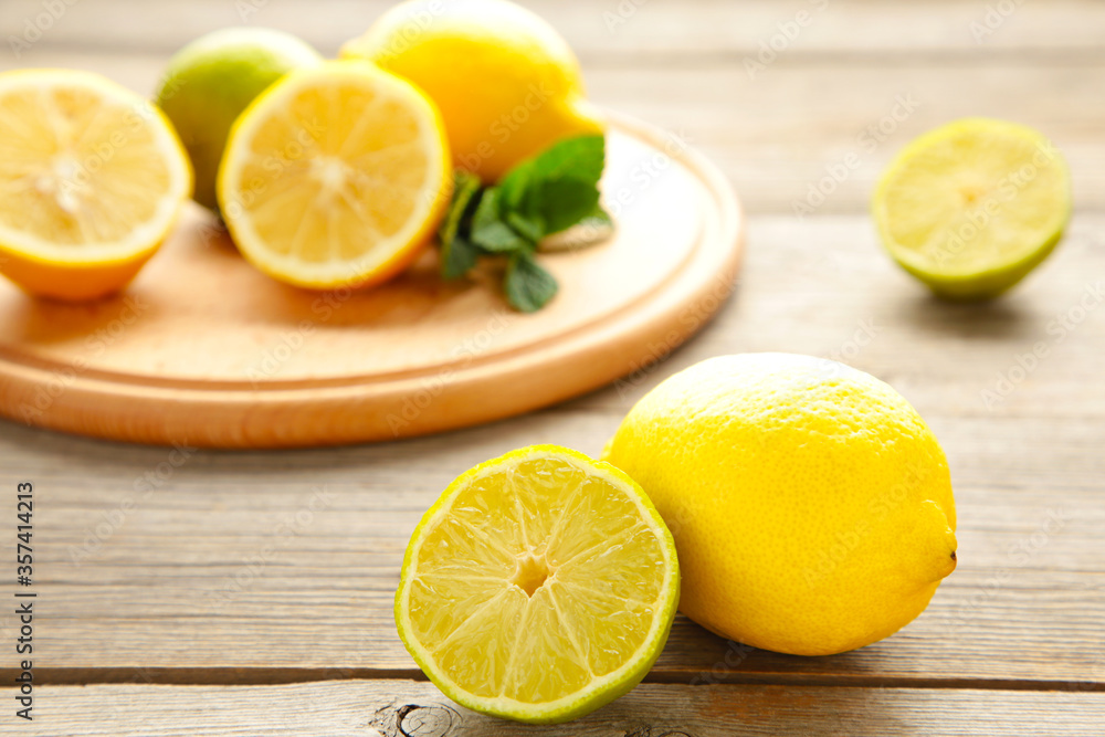Fresh ripe citruses with mint on grey wood table Fresh ripe citruses with mint on grey wood table