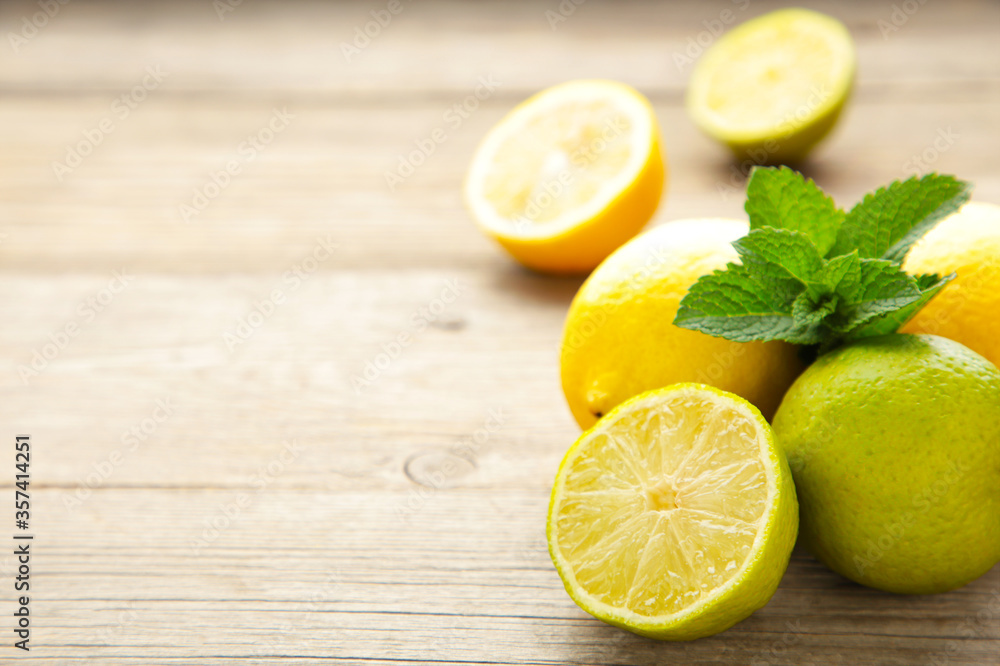 Fresh ripe citruses with mint on garden wood table Fresh ripe citruses with mint on garden wood table