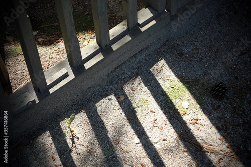 shadow lines of a fence on the ground.