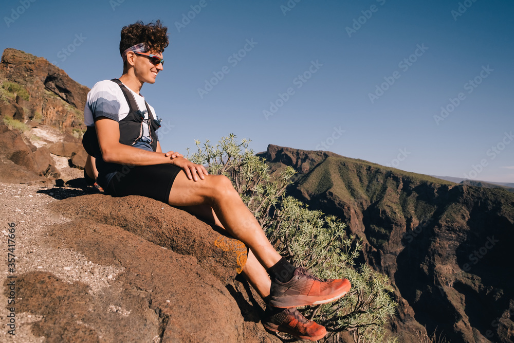 Portrait of young man resting after trail running