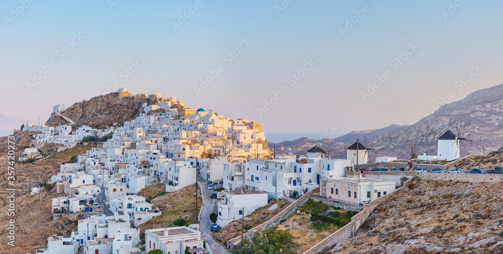 The chora - capital with traditional white houses of Serifos island Aegean Cyclades Greece against a blue sky on sunset on summer