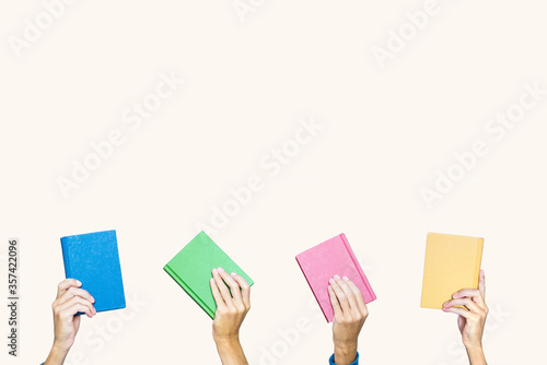 Background with hands holding colorful books