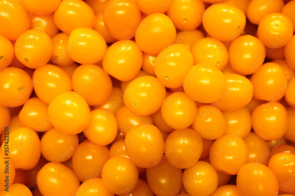 a pile of vegetables yellow mini tomatoes as background a pile of vegetables yellow mini tomatoes as background