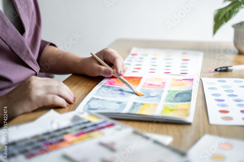 Creative design artist painting colour in art book.
