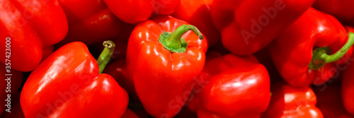 a pile of vegetables red sweet bell peppers as background. banner