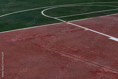 close up empty red and green basketball court floor with white lines. sport theme wallpaper