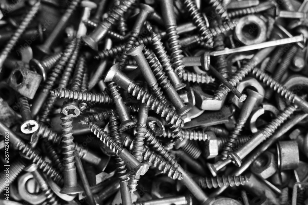 assortment of bolts and screws top view, black and white assortment of bolts and screws top view, black and white