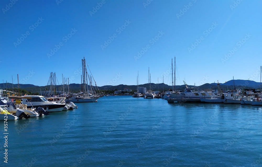 Ibiza, Port of San Antonio - October 16, 2019:boats at sea, mountains in the backround