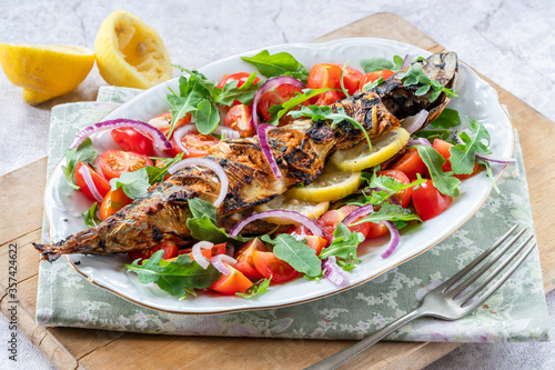 Grilled mackerel in spicy coating with fresh salad