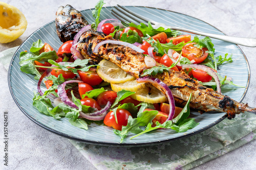 Grilled mackerel in spicy coating with fresh salad