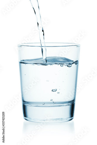 Wallpaper Mural Water is poured into a glass of water. Isolated on a white background. Torontodigital.ca