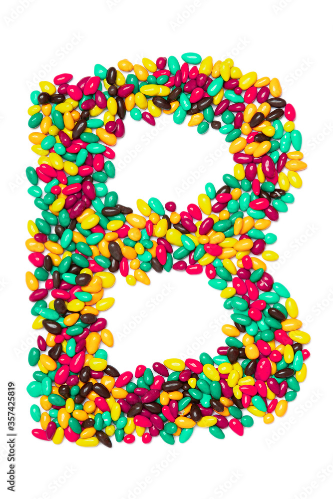 Letter B of the English alphabet from multicolored round chocolates on a white isolated background. Food pattern made from children's candy. Bright alphabet for kids design Letter B of the English alphabet from multicolored round chocolates on a white isolated background. Food pattern made from children's candy. Bright alphabet for kids design