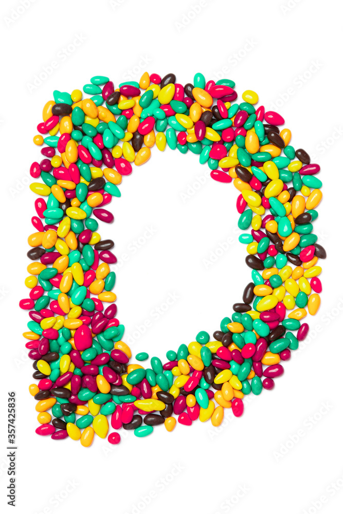 Letter D of the English alphabet from multicolored round chocolates on a white isolated background. Food pattern made from children's candy. Bright alphabet for kids design Letter D of the English alphabet from multicolored round chocolates on a white isolated background. Food pattern made from children's candy. Bright alphabet for kids design