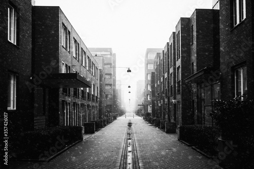 Black and white image of modern residential houses and a narrow street in the Nieuw West district Osdorp in Amsterdam