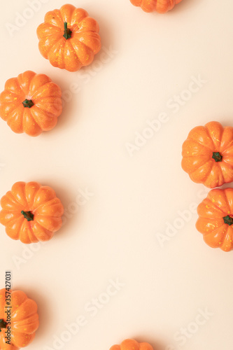 Autumn Minimal composition. Autumn, fall, thanksgiving day, halloween concept. Yellow background with pumpkins. Top view, flat lay