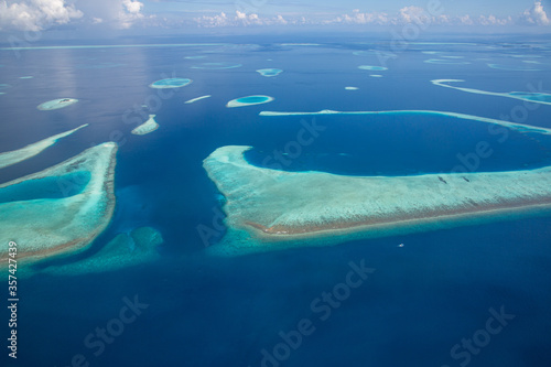 Aerial view of Maldives atolls is the world top beauty. Maldives tourism. Luxury travel destination  amazing nature environment  islands atoll and coral reef. Tropical landscape  aerial view