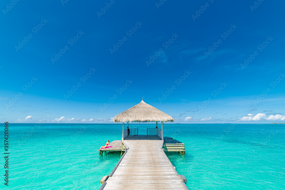 Over water luxurious spa in the tropical blue lagoon of Maldives. Amazing shades of blue, ocean horizon. Exotic travel destination, Maldives summer holiday concept
