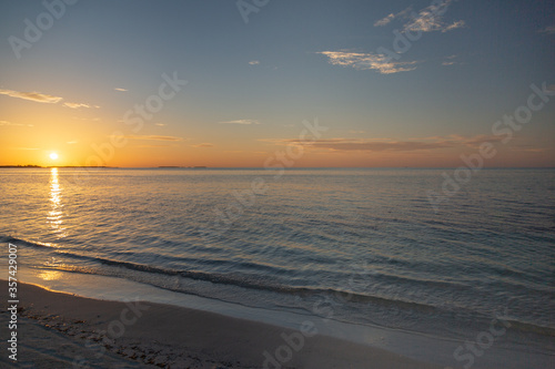 Inspirational calm sea with sunset sunrise sky. Meditation ocean and sky background. Colorful horizon over the water. Tropical beach surf of coast or shore