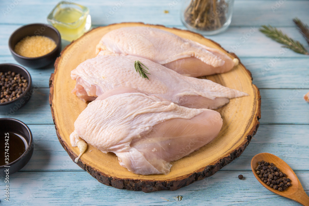 Raw chicken, on a wooden board, meat containing ingredients for cooking