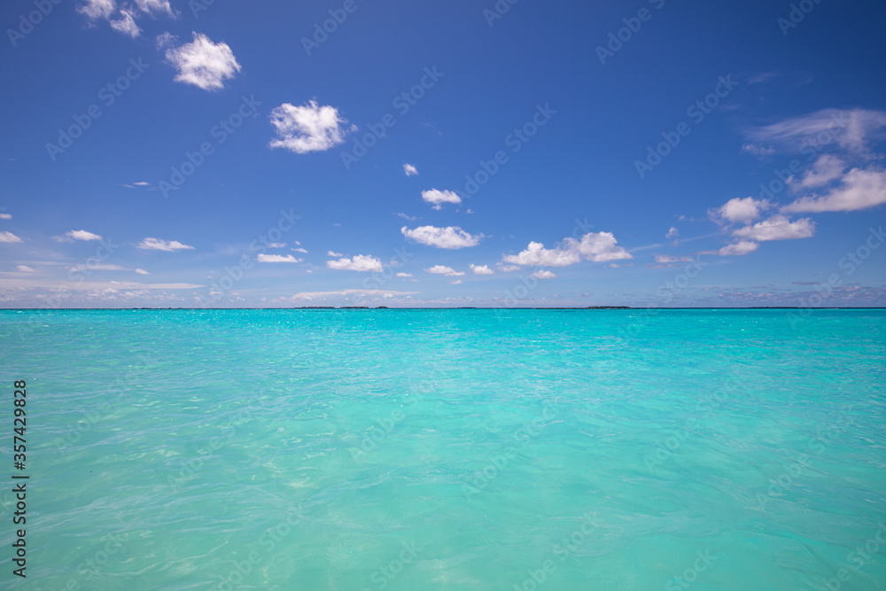 Tropical sea under the blue sky. Exotic seascape, crystal clear ocean water with endless view over the horizon Tropical sea under the blue sky. Exotic seascape, crystal clear ocean water with endless view over the horizon