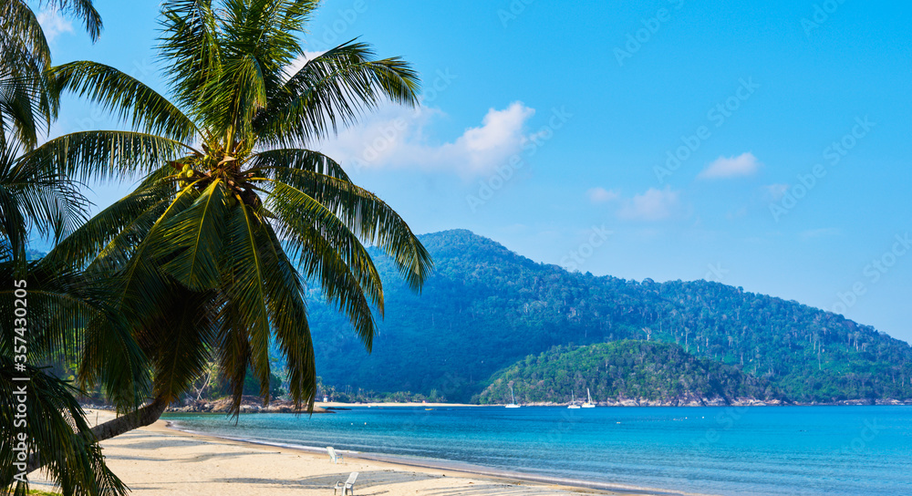 Fototapeta premium Beautiful view on the beach in a tropical resort. Landscape of paradise tropical island beach. Perfect getaway. View of beauty of island.