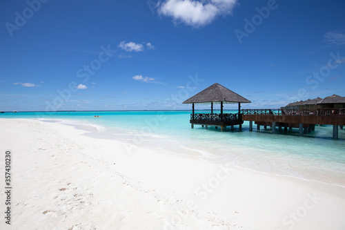 Amazing tropical over water bungalow resort on the beach. Luxury vacation, summer holiday beach landscape with copy space. White sand and blue sea sky, turquoise lagoon for travel template