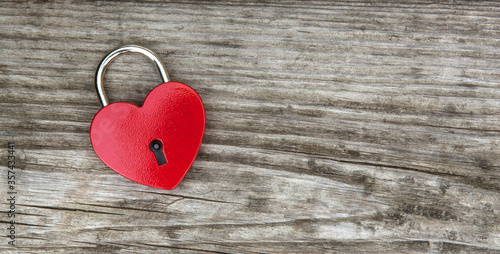 heart shaped padlock on wooden background