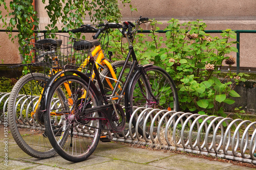 Modern Parking lot with Bicycles near an apartment red brick building with large number of bicycles. Eco-friendly and sports transport in the city.