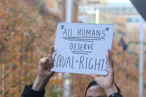 Sydney, NSW / Australia - June 6 2020: Black Lives Matter Protest March. Protesting Aboriginal deaths in custody and the death of. Sign reading 'all humans deserve equal rights'.