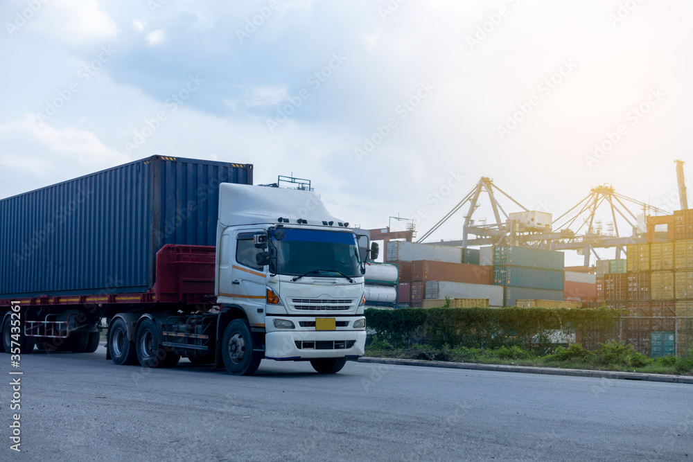 Container blue truck in ship port Logistics.Transportation industry in port business concept.import,export logistic industrial Container blue truck in ship port Logistics.Transportation industry in port business concept.import,export logistic industrial