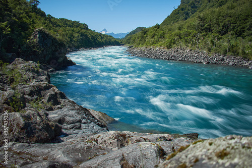 PETROHUE, CHILE - FEBRUARY 11, 2020: The waterfalls, rapids and tourists of Petrohue on a sunny day in the lake region of Chile, near of Puerto Varas. Turquoise water.