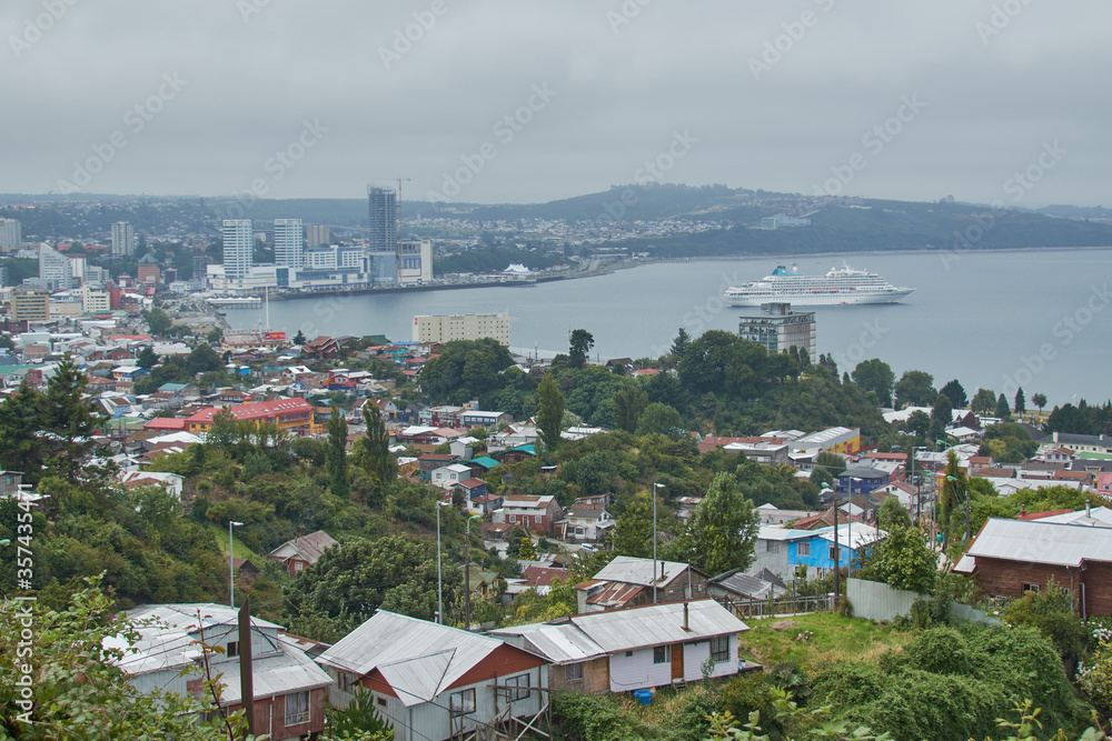 PUERTO MONTT, CHILE - FEBRUARY 10, 2020: Panoramic view of Puerto Montt, Lake District, Chile. Big cruise in the bay. PUERTO MONTT, CHILE - FEBRUARY 10, 2020: Panoramic view of Puerto Montt, Lake District, Chile. Big cruise in the bay.