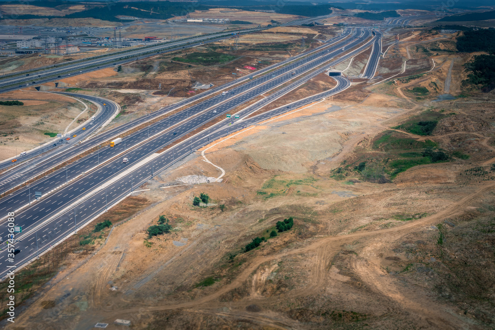 Landing at Turkey airport in Istanbul. Aerial view from airplane of landscape and highway. Amazing infrastructure and poor soil. Wide shot at daylight