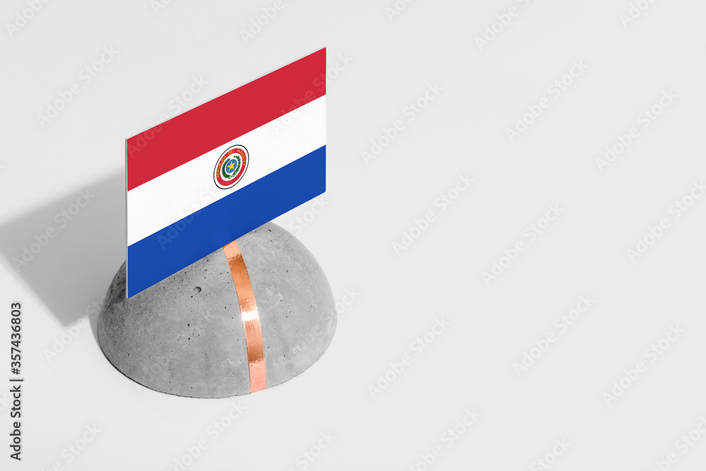 Naklejka premium Paraguay flag tagged on rounded stone. White isolated background. Side view minimal national concept.