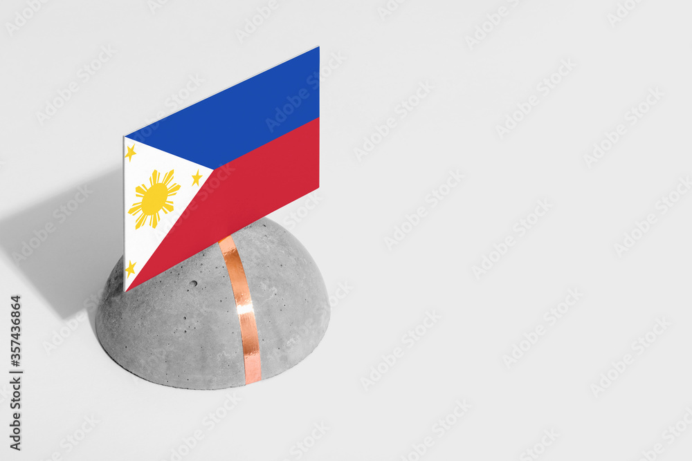 Naklejka premium Philippines flag tagged on rounded stone. White isolated background. Side view minimal national concept.