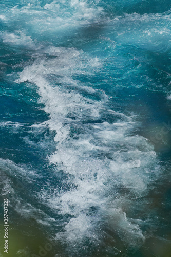 PETROHUE, CHILE - FEBRUARY 11, 2020: The waterfalls, rapids and tourists of Petrohue on a sunny day in the lake region of Chile, near of Puerto Varas. Turquoise water.