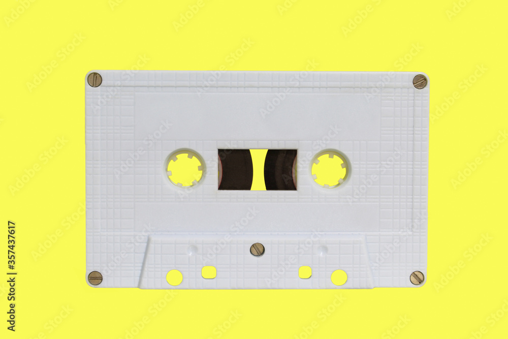 Obraz premium White audio cassette isolated on yellow background. Old vintage Cassette tape 