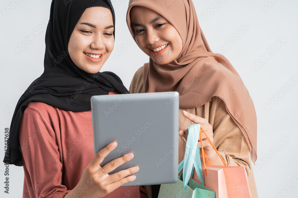 happy muslim woman shopping holding tablet on white background happy muslim woman shopping holding tablet on white background