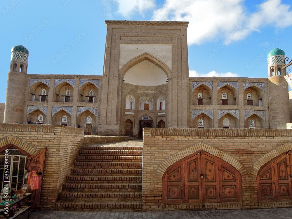 Street view onto main facade of former Khoja Merdibai Madrasah, decorated with traditional ornaments, Khiva, Uzbekistan. As all the city buildings this is included in UNESCO Heritage List