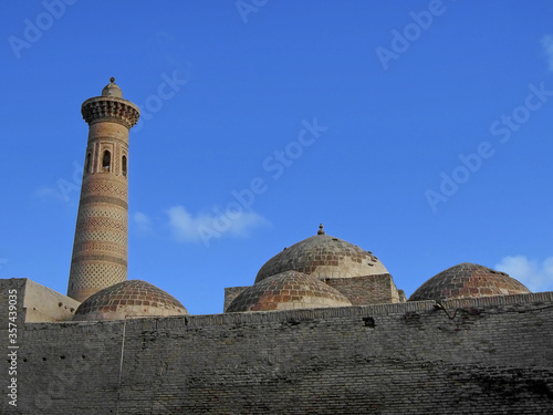 Minaret, domes & outer wall of Sayid Niaz Sheliker Mosque in Khiva, Uzbekistan. Place located outside of traditional tourist routs. Despite of it, this building is deserving sight by its architecture photo