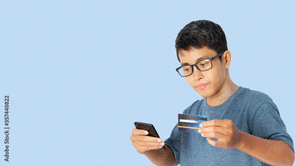 Young Asian man with a credit card payment for online shopping concept. Young Asian man with a credit card payment for online shopping concept.