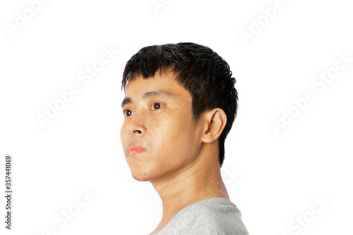 Closeup of a young Asia man looks ahead .