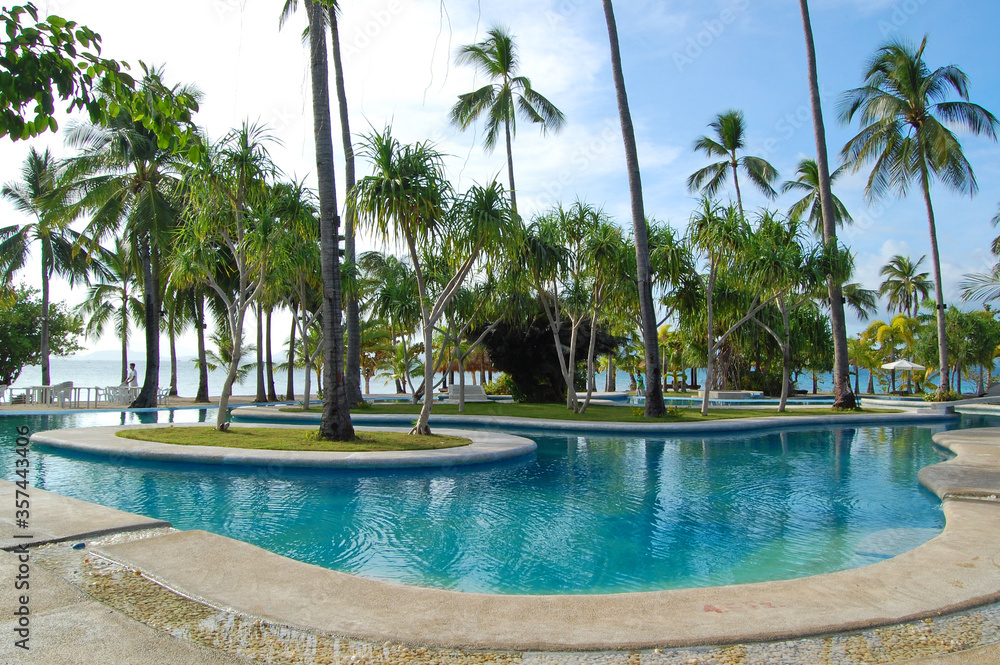 Swimming pool and coconut trees at Dos Palmas island resort in Honda Bay, Puerto Princesa, Palawan, Philippines
