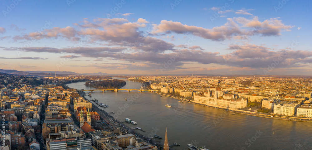 Aerial drone sunset view of Hungarian Parliament by Danube river with dramatic clouds in Budapest