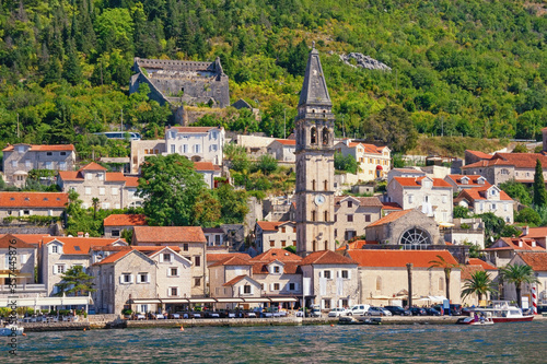 View of ancient town of Perast with bell tower of St Nicholas church on sunny autumn day. Bay of Kotor, Montenegro