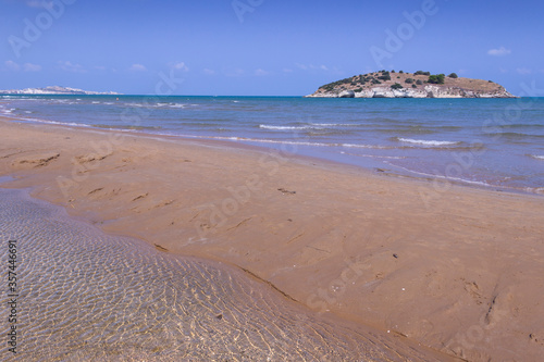 Summertime relax.The most beautiful coasts of Italy: bay of Vieste, (Apulia, Gargano). In the foreground the Gattarella islet and in the background the town of Vieste. photo