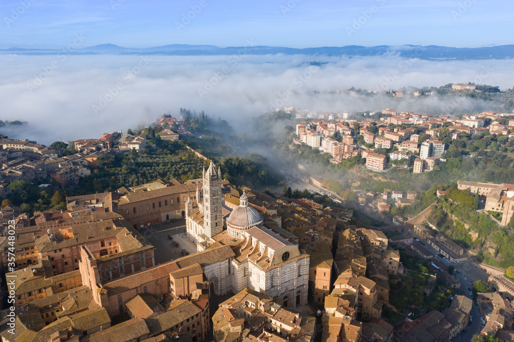 aerial view of the city of Siena with the fog Tuscany