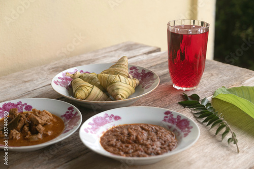 Ketupat (rice dumpling) served with red syrup,meat curry and peanut sause is a popular or signature dish made from rice packed. It usually served during festive season of Eid Mubarak / Ied Fitr or ram