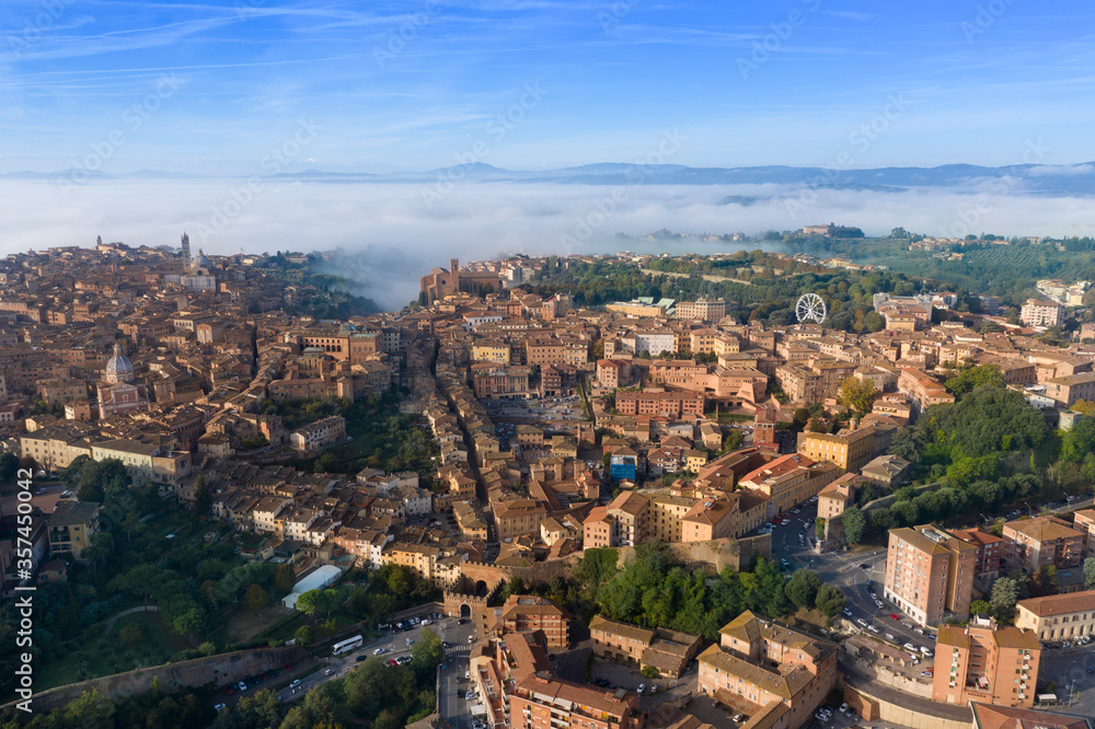 aerial view of the city of Siena with the fog Tuscany