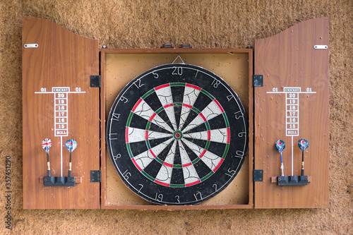 Game Dart board on wooden background